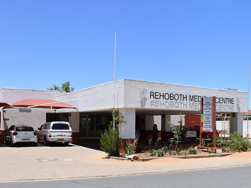 Front exterior view of the Rehoboth Medical Centre featuring a covered entrance, paved parking area, and prominent building signage.