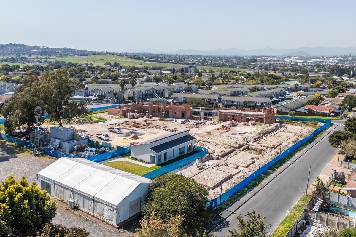 Aerial view of a residential development site in progress, showing ongoing construction of apartment structures and site infrastructure.