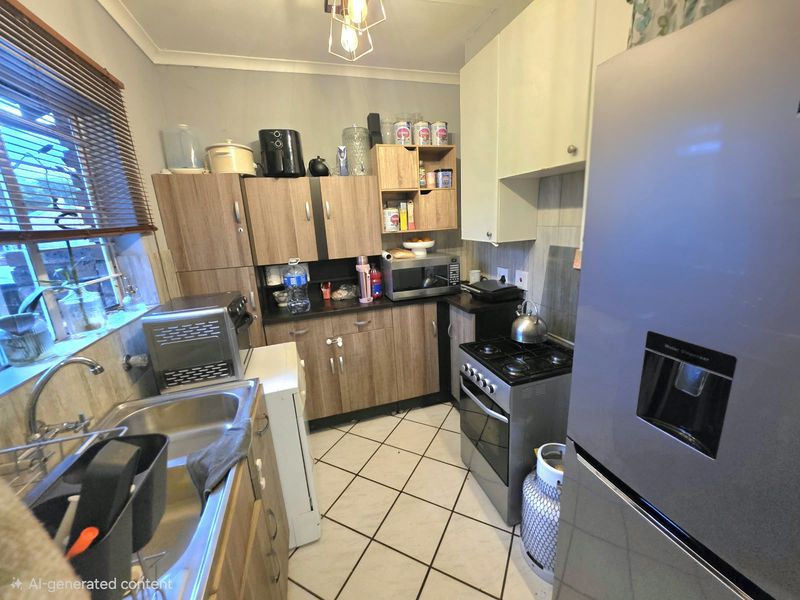 A functional kitchen featuring laminate cabinetry, a stainless steel sink, gas stove, and tiled flooring with a tiled backsplash.