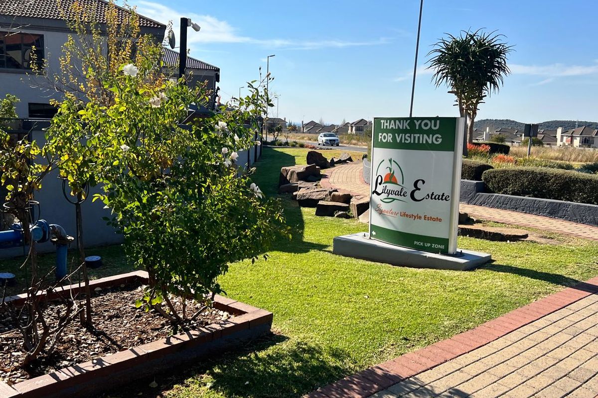 Entrance view of Lilyvale Estate featuring manicured lawns, paved pathways, and established estate signage.