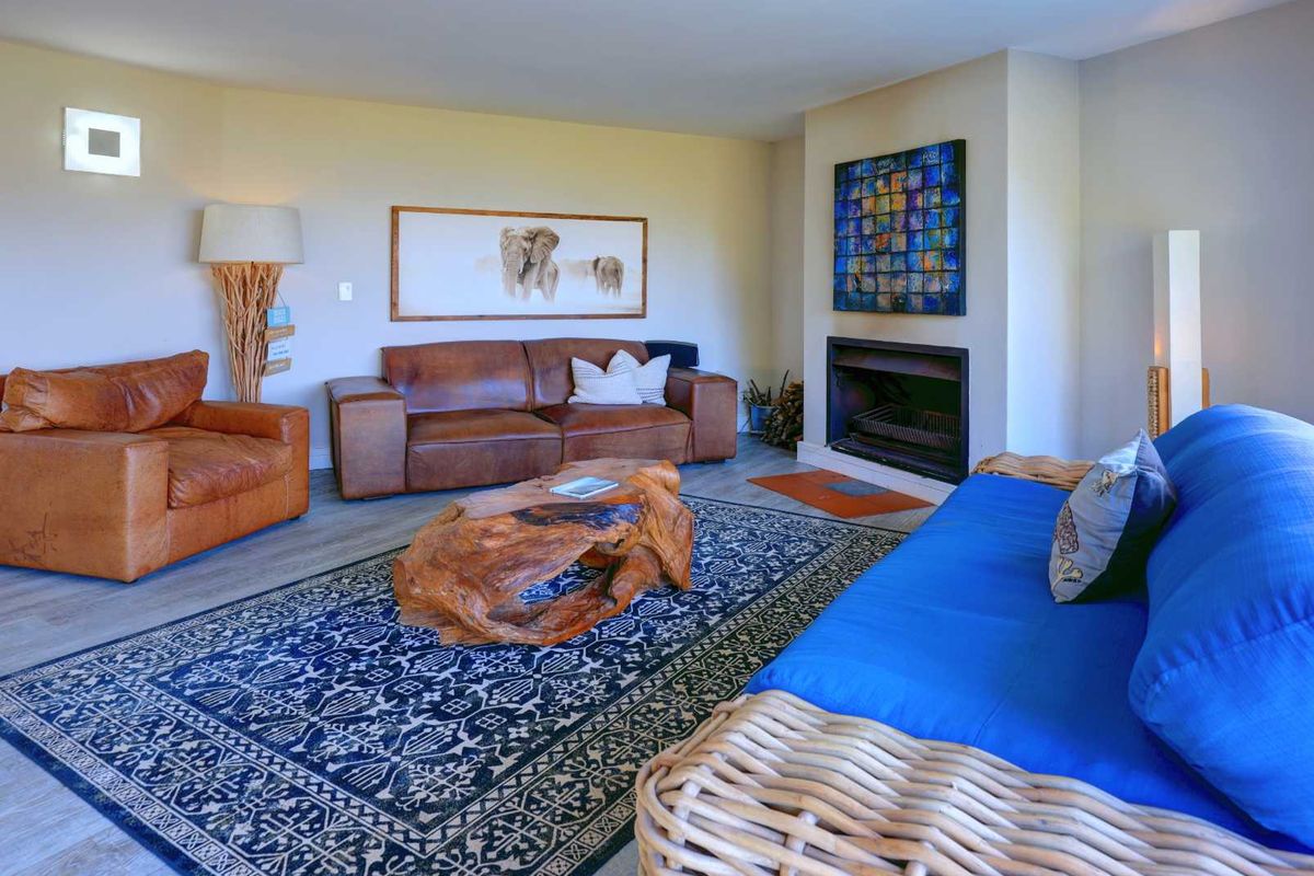 A comfortable living room featuring a built-in fireplace and neutral wall finishes, providing a warm and inviting space for relaxation.