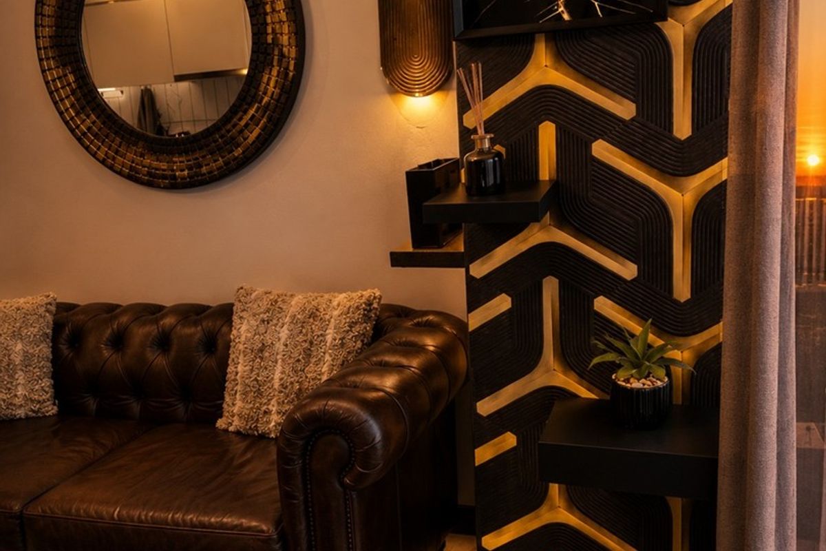 A stylishly appointed living area featuring custom decorative wall paneling, integrated accent lighting, and high-quality finishes.