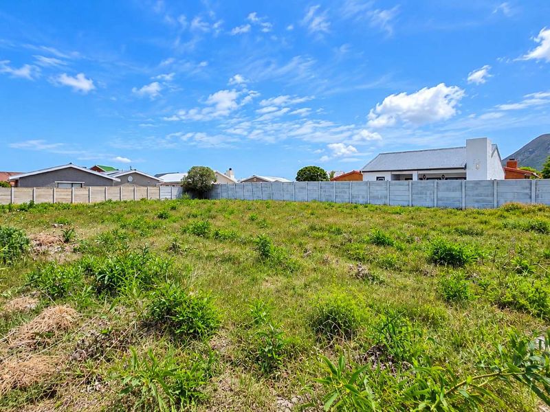 A vacant residential plot of land featuring a precast concrete boundary wall, ready for development in a established neighbourhood.