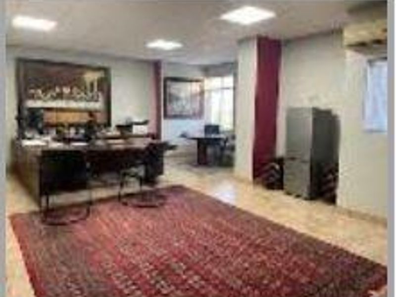 A functional office space featuring tiled flooring, recessed ceiling lighting, and an integrated air conditioning unit.
