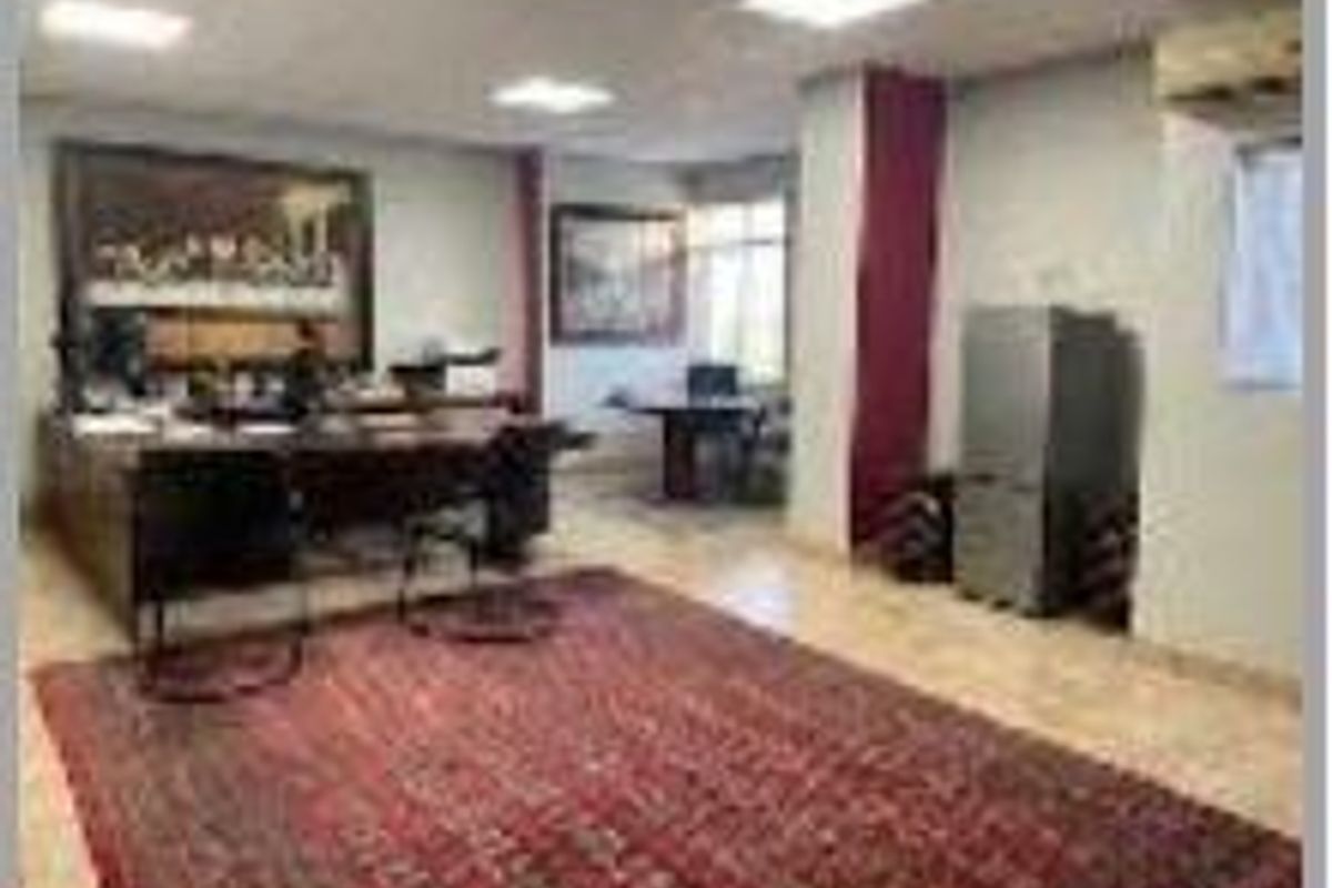 A functional office space featuring tiled flooring, recessed ceiling lighting, and an integrated air conditioning unit.