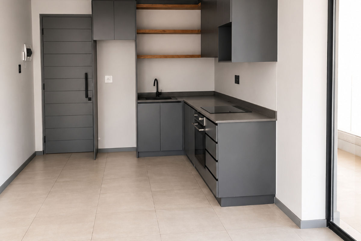 Modern, minimalist kitchen featuring dark grey cabinetry, integrated oven, electric hob, open timber shelving, and neutral floor tiles in an open-plan layout.