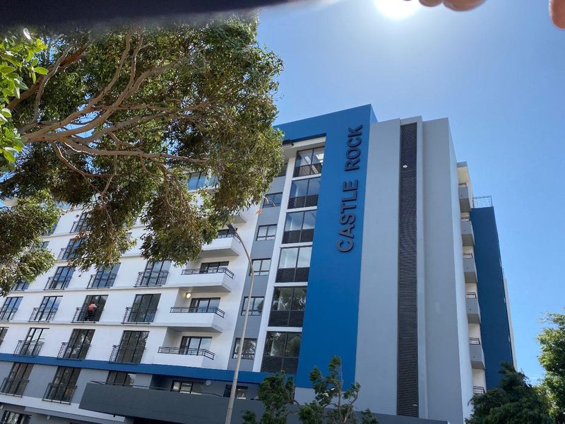 Exterior view of the Castle Rock apartment building, featuring modern facade design and private balconies.