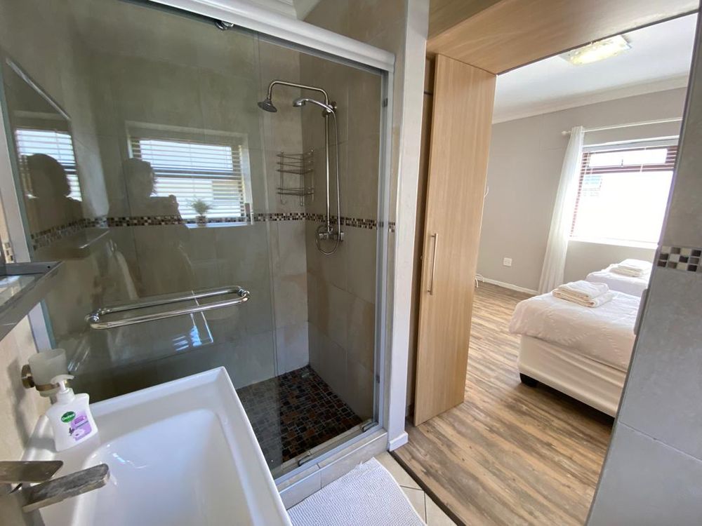 Ground floor, bedroom 3 with built-in cupboards, TV and en-suite bathroom. 