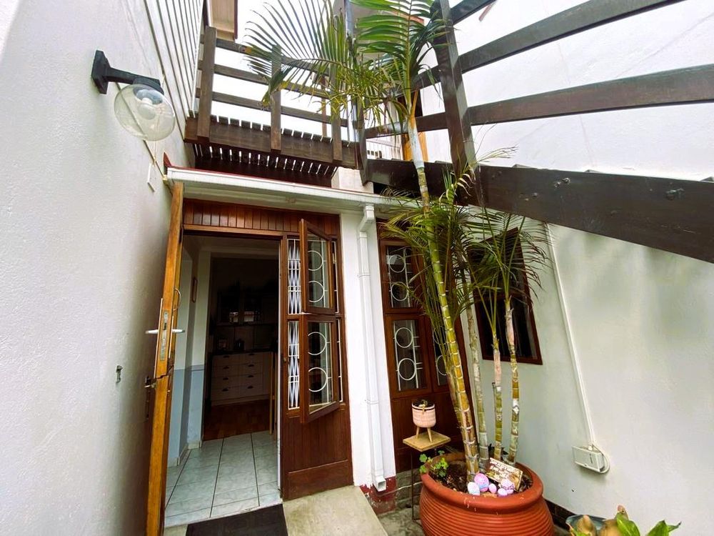 Kitchen entrance and stairs leading to the third bedroom and one of the flats