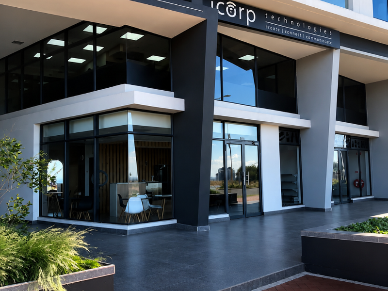 Modern commercial storefront featuring large glass windows, tiled entrance area, and contemporary architectural design, suitable for retail or office use.