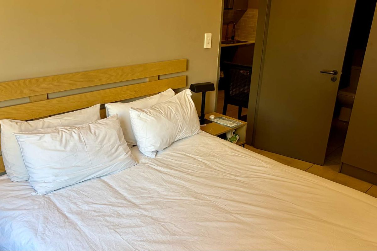 A bedroom featuring a built-in wardrobe and an internal door leading to an adjacent space.