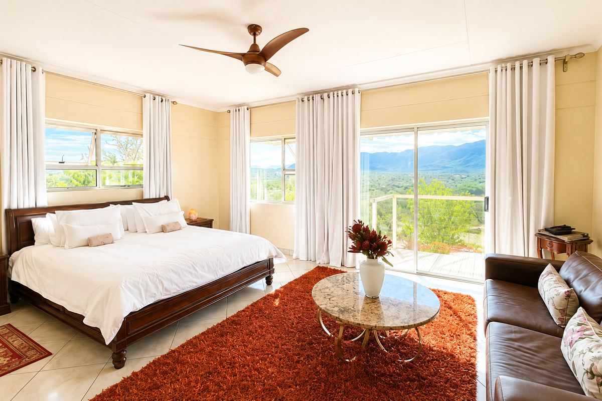Spacious bedroom featuring tiled floors, a ceiling fan, and large sliding glass doors that open to scenic mountain views.
