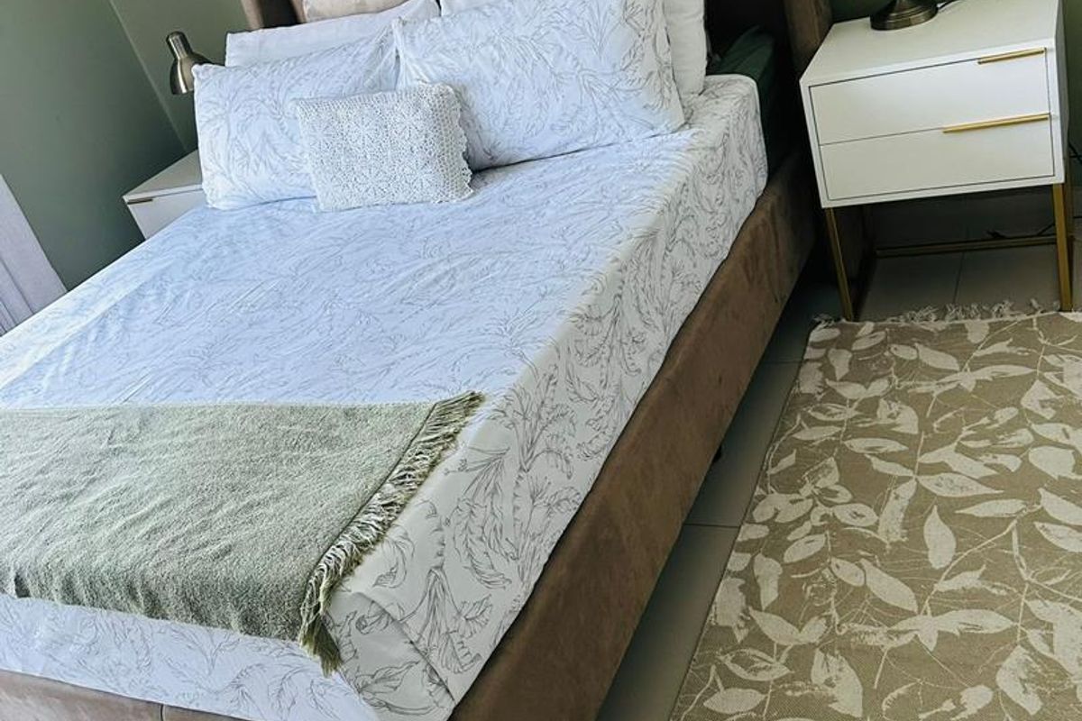 A well-maintained bedroom featuring neutral wall tones, tiled flooring, and a modern layout suitable for comfortable living.