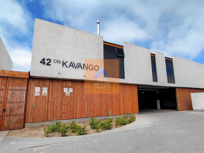 Modern apartment complex facade featuring timber slat cladding, stucco finish, and a paved driveway entrance with integrated signage.