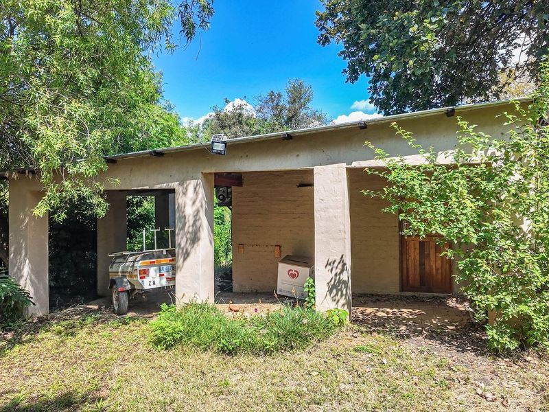 A detached outdoor structure featuring a covered patio area, suitable for storage or conversion into a workshop or garden studio.