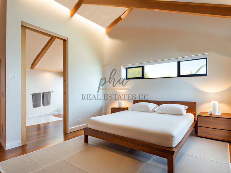 Spacious bedroom featuring vaulted ceilings with exposed timber beams, warm hardwood flooring, and modern recessed lighting, creating a bright and airy atmosphere.