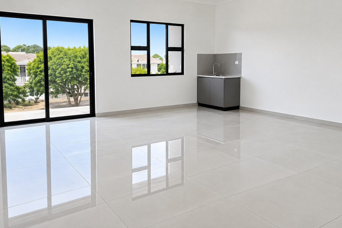 Modern, bright office space featuring polished porcelain tiles, a convenient kitchenette, and large sliding glass doors providing ample natural light and outdoor access.