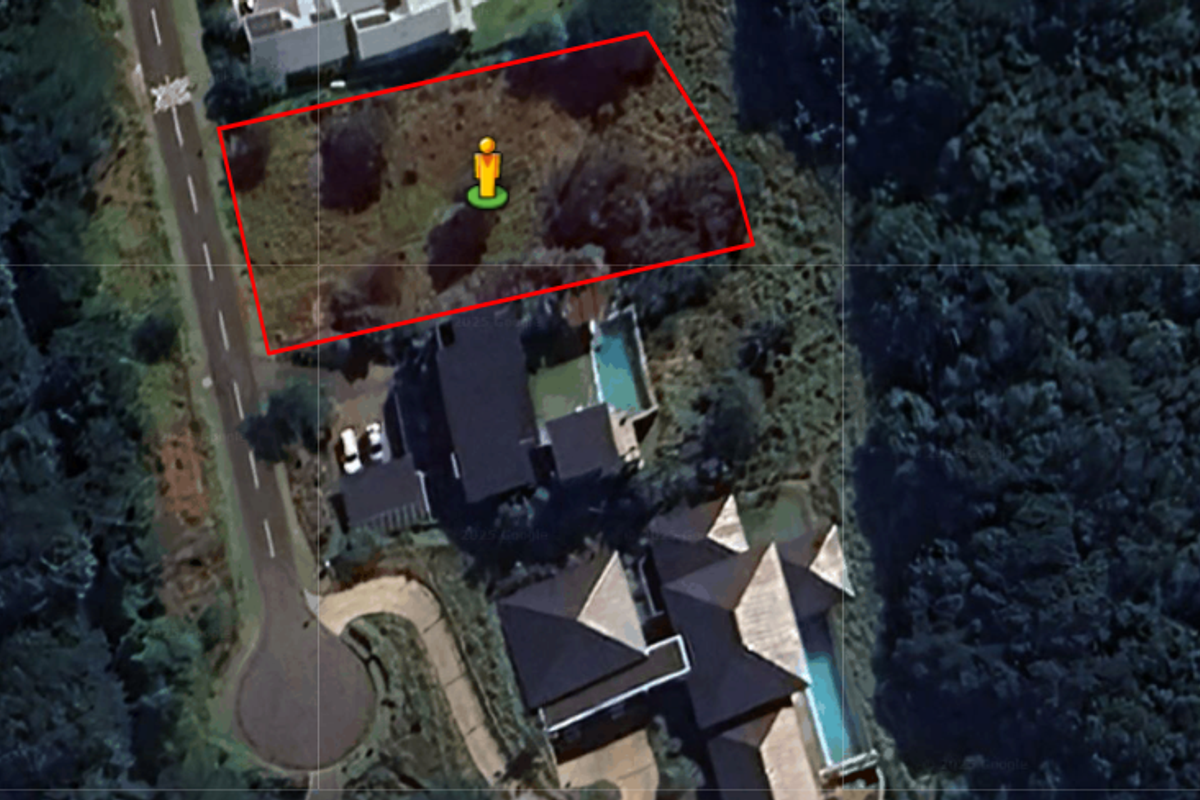 Aerial view of a vacant residential plot of land, showing its location relative to the street and surrounding properties.