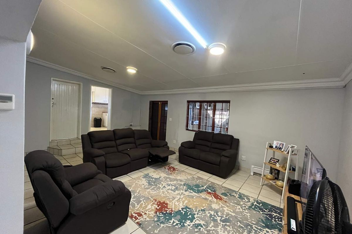 Spacious living room featuring tiled flooring, recessed ceiling lighting, and direct access to adjacent rooms.