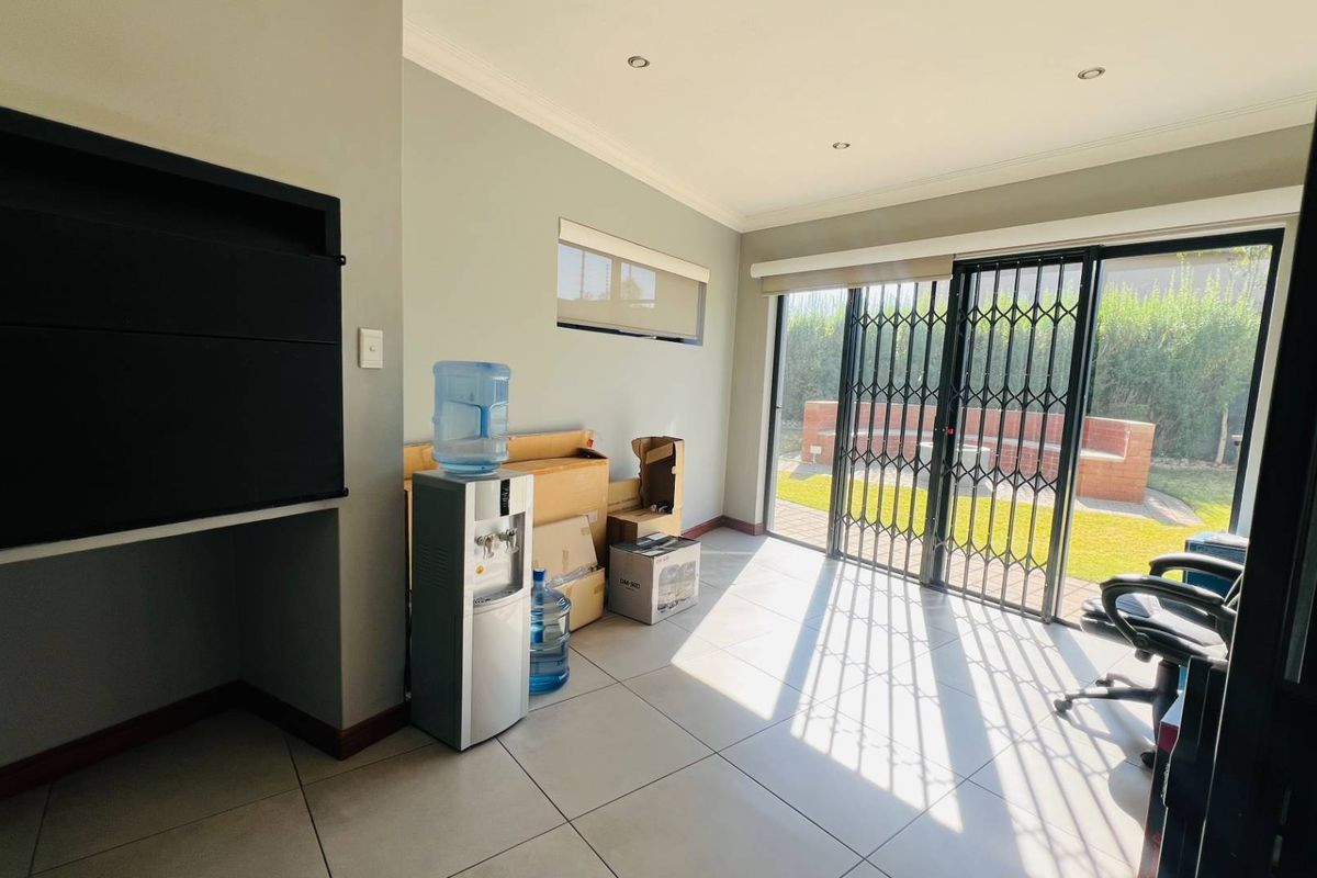 Bright living area featuring tiled floors, recessed lighting, and sliding glass doors providing direct access to the rear patio and garden.