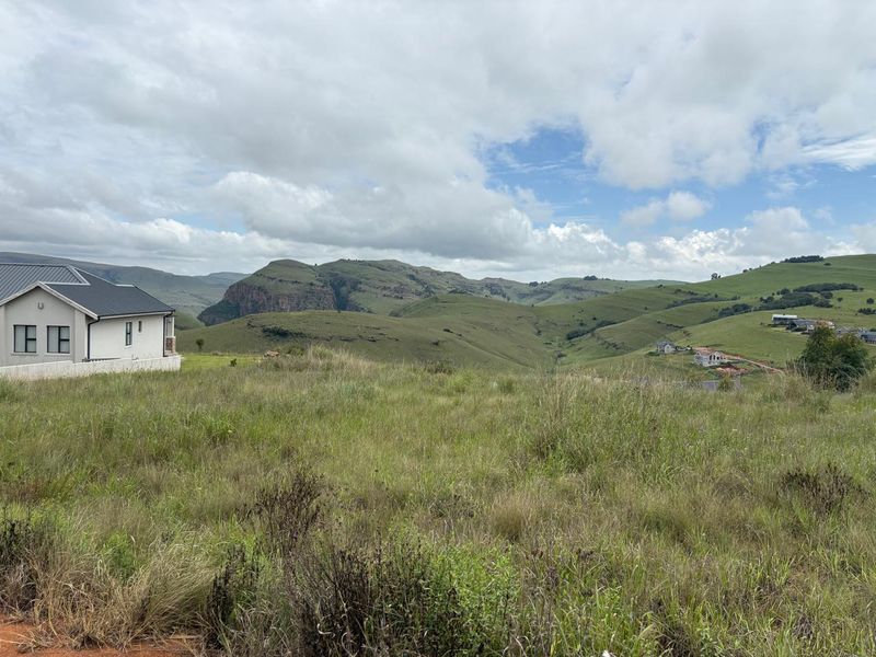 A scenic view of the surrounding mountainous landscape and rolling hills from the vacant residential property.