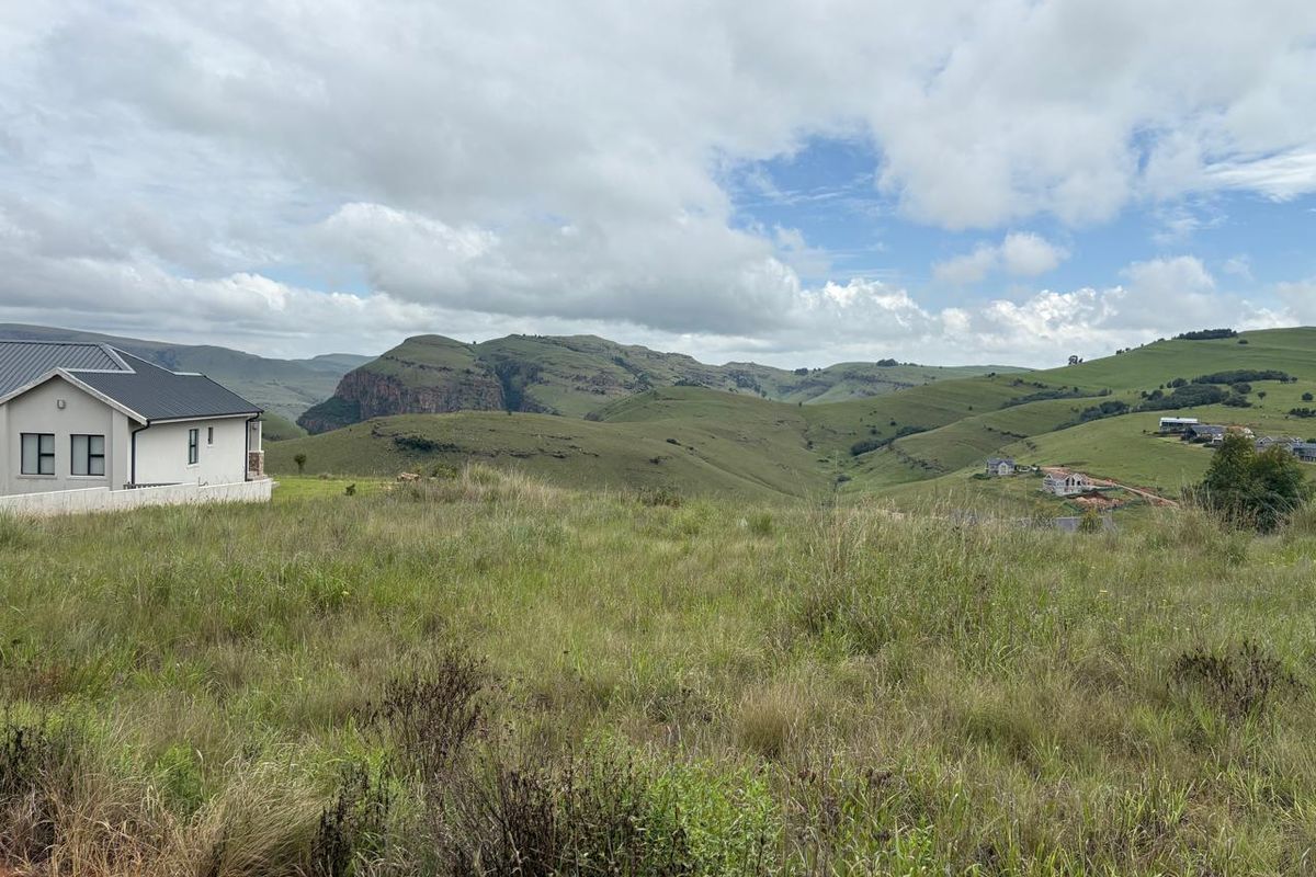 A scenic view of the surrounding mountainous landscape and rolling hills from the vacant residential property.