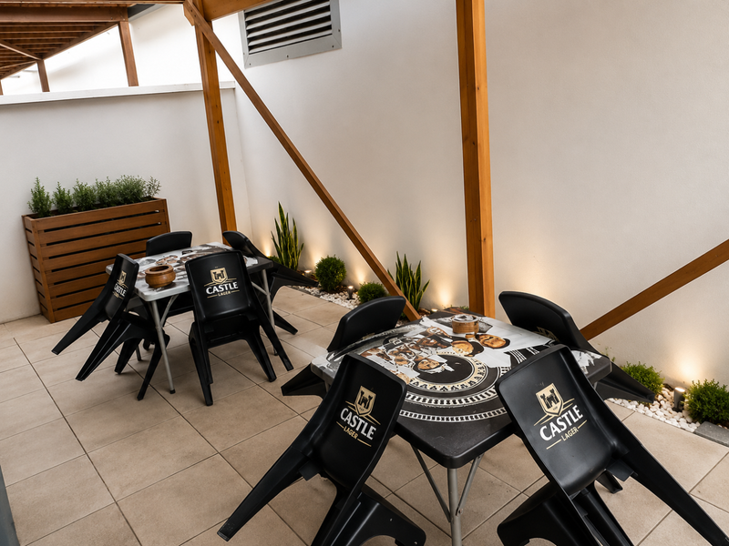 A covered outdoor patio area featuring tiled flooring, a timber pergola structure, recessed wall lighting, and a built-in planter box.