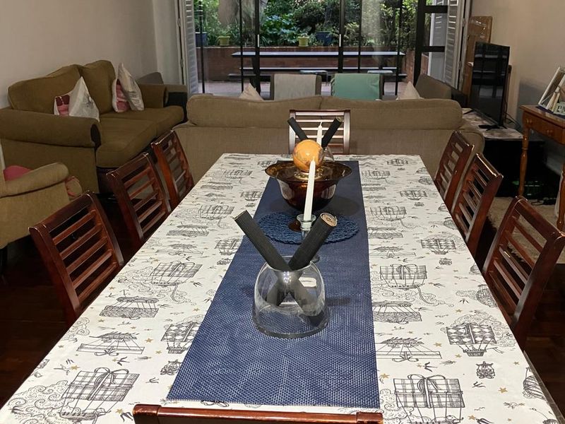 Open plan living and dining area featuring hardwood flooring and large sliding glass doors leading to an outdoor patio space.
