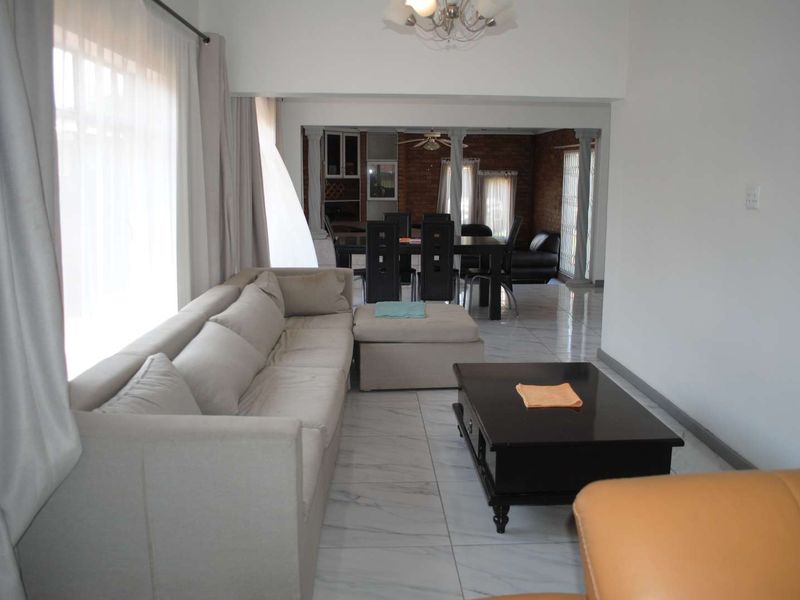 Renovated, built up, and expanded into a neat four-bedroom home with multiple living rooms and Bar area - Photo 4