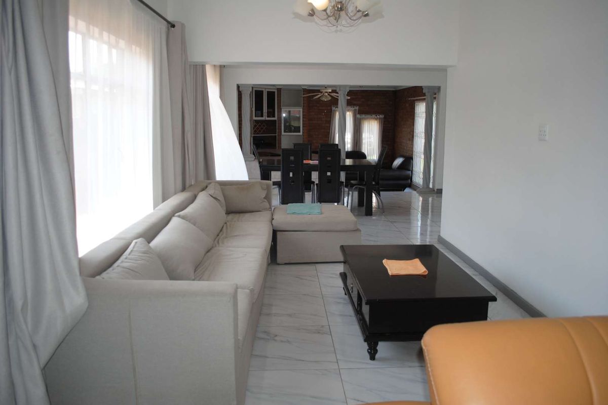 Renovated, built up, and expanded into a neat four-bedroom home with multiple living rooms and Bar area - Photo 4