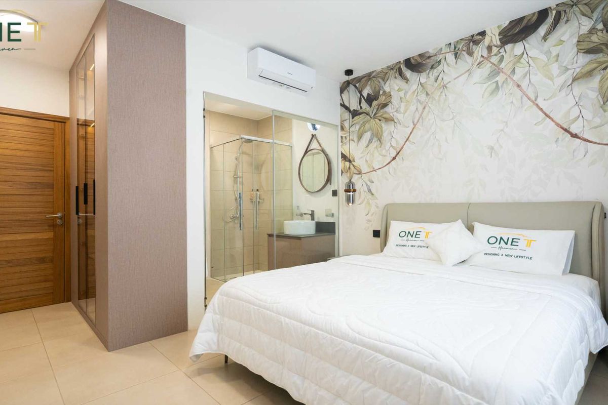 Modern bedroom featuring an en-suite bathroom with a glass-enclosed shower, built-in wardrobe, and wall-mounted air conditioning unit.