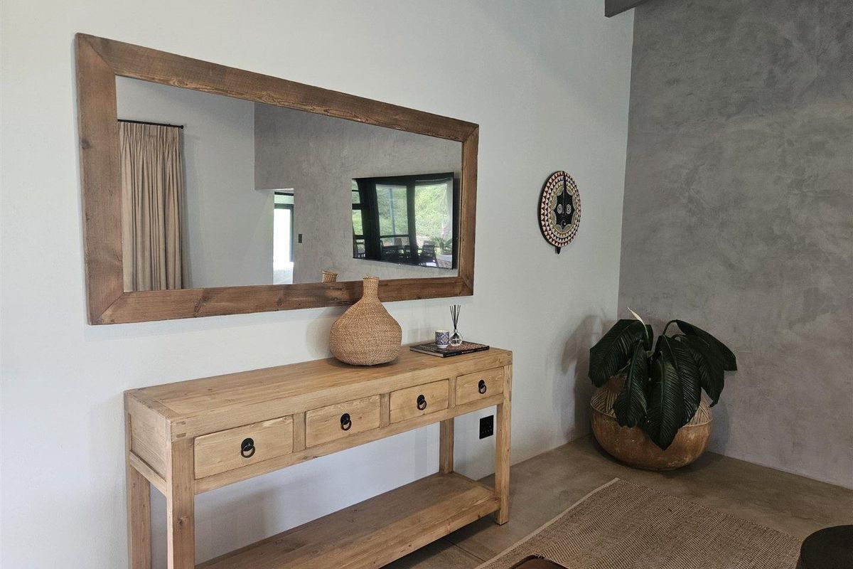 A modern living area featuring a textured concrete accent wall and polished concrete flooring, creating a contemporary and minimalist aesthetic.