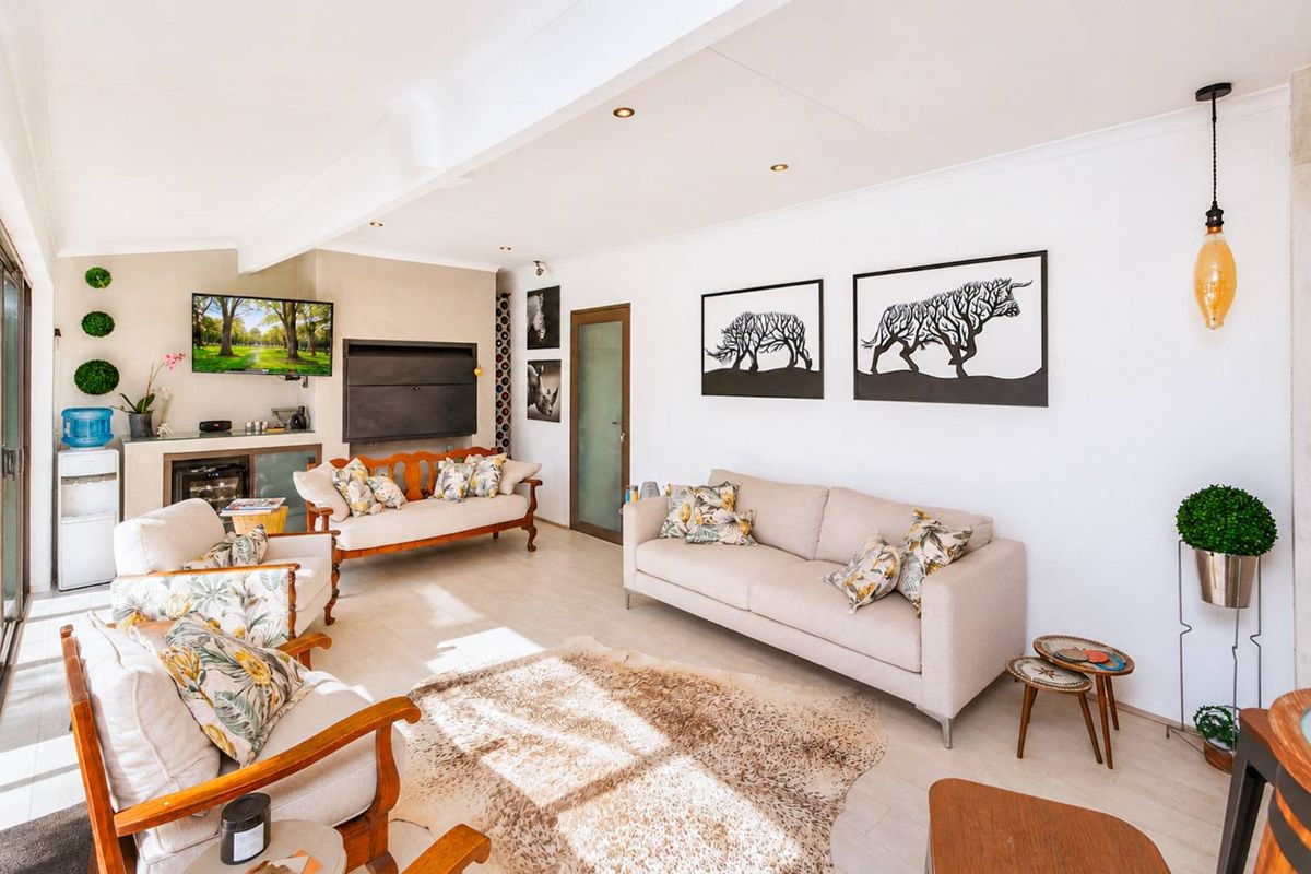 A bright and spacious living room featuring a built-in fireplace, recessed ceiling lighting, and large sliding glass doors providing ample natural light.