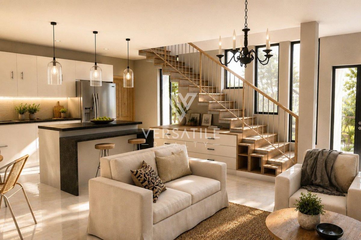 Modern open-plan living area featuring a sleek kitchen with island, elegant staircase with integrated storage, and bright, contemporary finishes throughout.