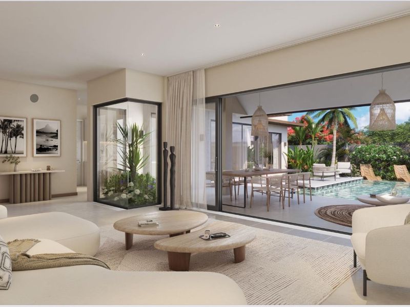 Spacious open-plan living area featuring large sliding glass doors that open onto a private patio and swimming pool area.