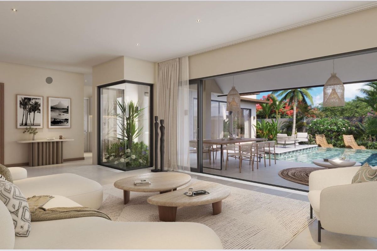 Spacious open-plan living area featuring large sliding glass doors that open onto a private patio and swimming pool area.