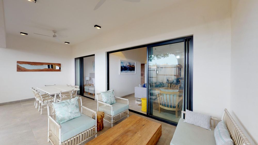 Patio with seating areas. Sliding doors leading to both the lounge and one of the bedrooms