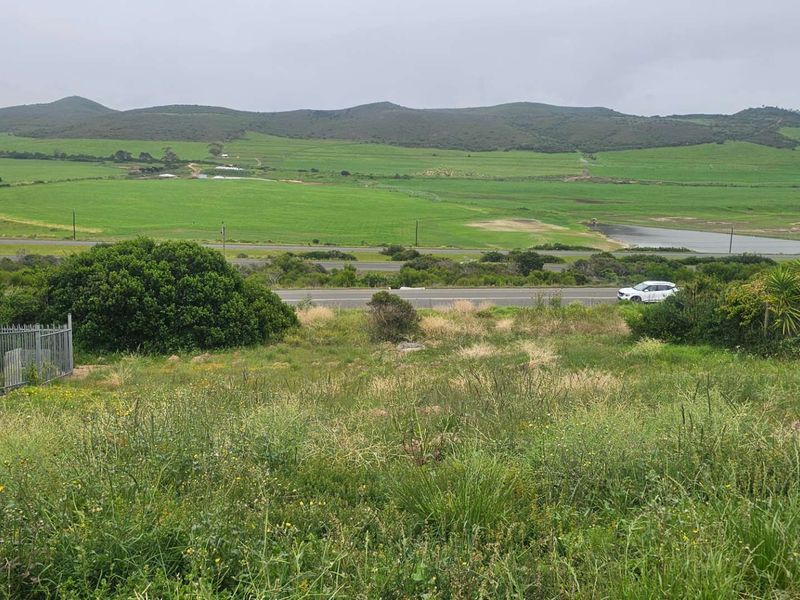 Expansive view of the surrounding landscape, green fields, and distant hills from the vacant residential property.
