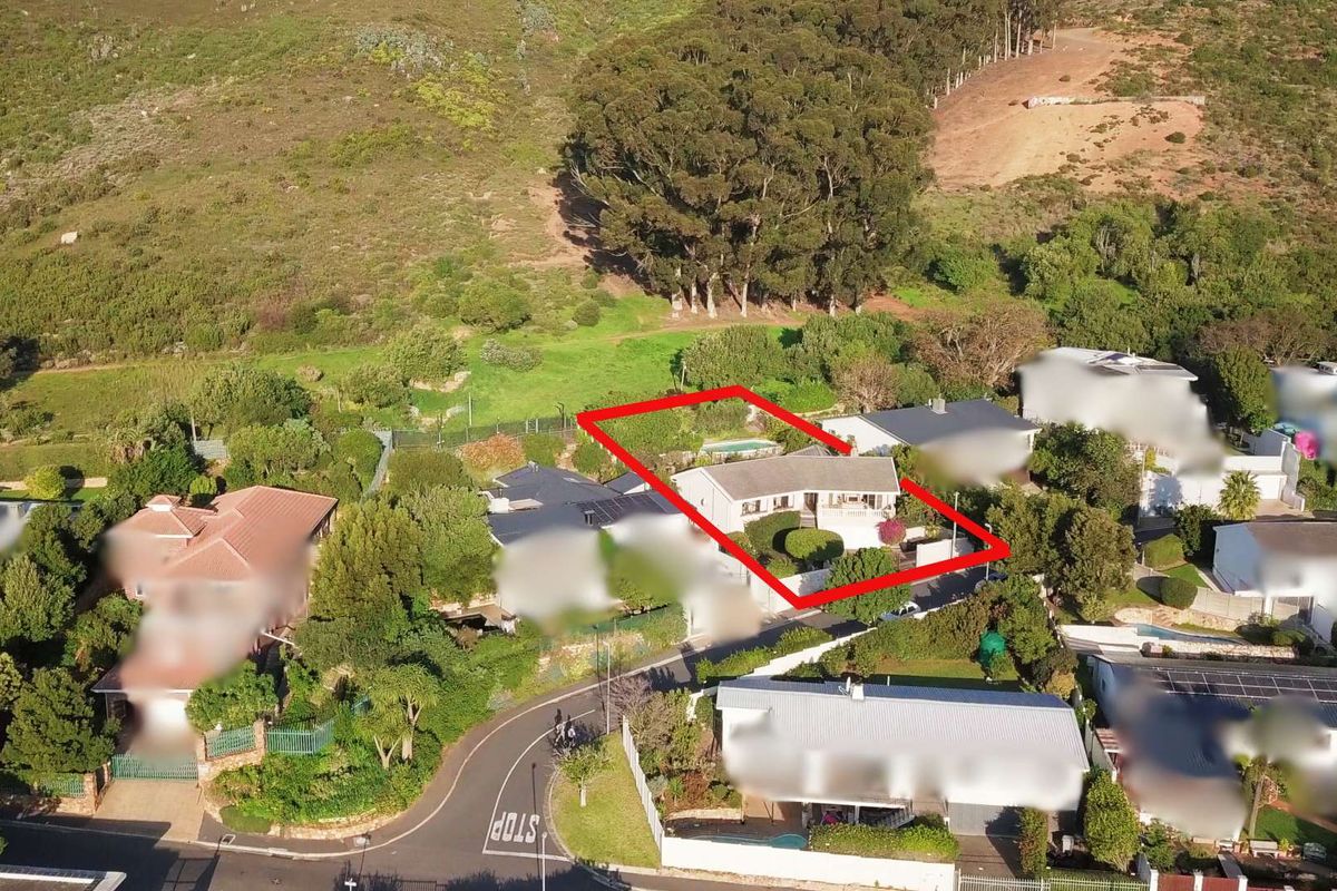 Aerial view of the residential property highlighting the plot boundaries, roof structure, and surrounding garden area with a swimming pool.
