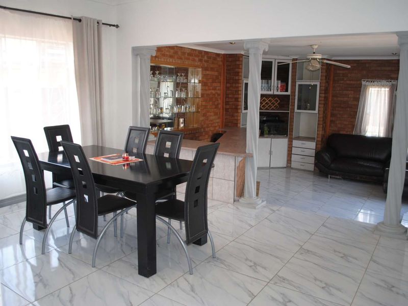 Renovated, built up, and expanded into a neat four-bedroom home with multiple living rooms and Bar area - Photo 5