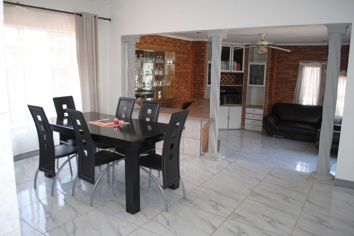 Renovated, built up, and expanded into a neat four-bedroom home with multiple living rooms and Bar area - Photo 5