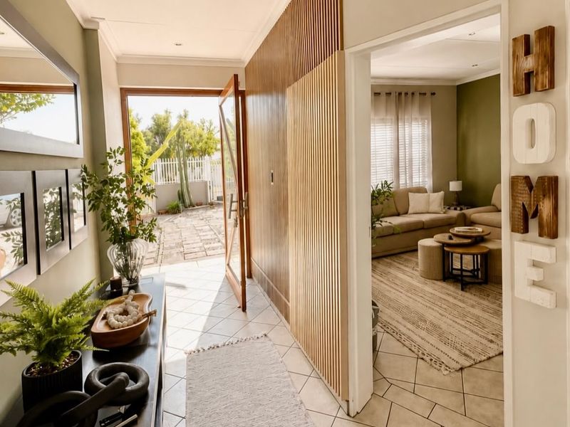 Welcoming entrance hall featuring modern tiled flooring and a stylish timber slat feature wall, providing a seamless transition into the adjacent living area.