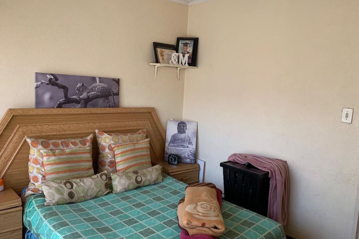 A standard bedroom featuring neutral wall finishes and coving detail.