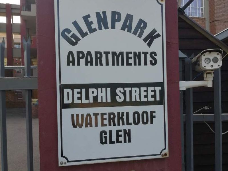 Entrance signage for Glenpark Apartments located on Delphi Street in Waterkloof Glen, featuring a security camera and gated access.