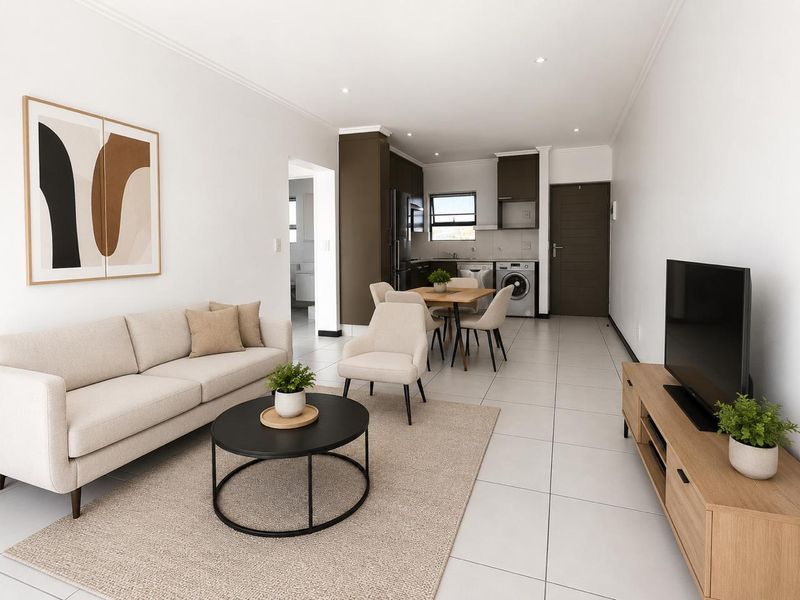 Modern open-plan living area featuring tiled floors, recessed lighting, and a functional kitchen space with built-in cabinetry and integrated laundry facilities.