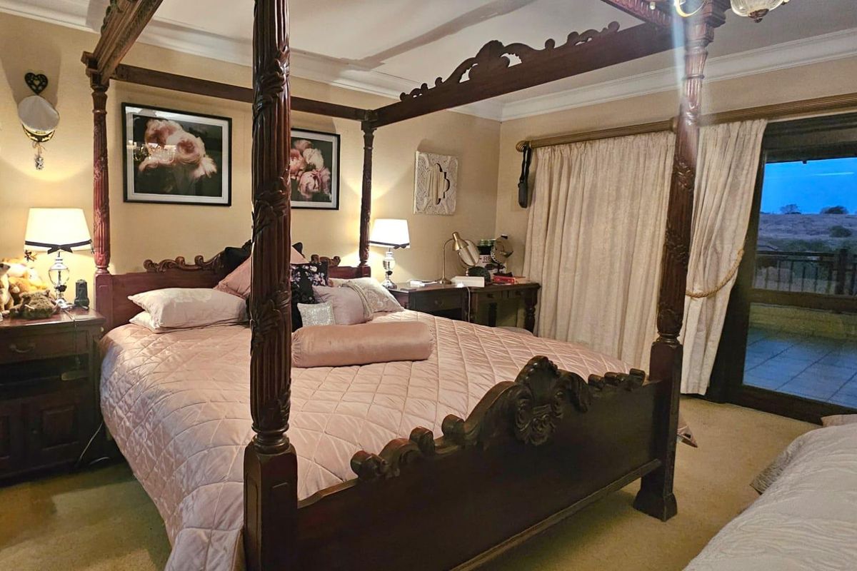 Spacious bedroom featuring crown molding, carpeted flooring, and a sliding glass door providing access to an outdoor area.