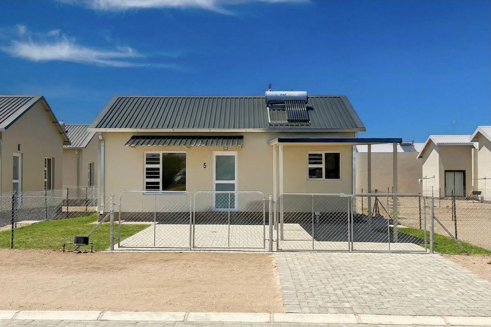 Freestanding townhouse with provision for future expansion and carport.