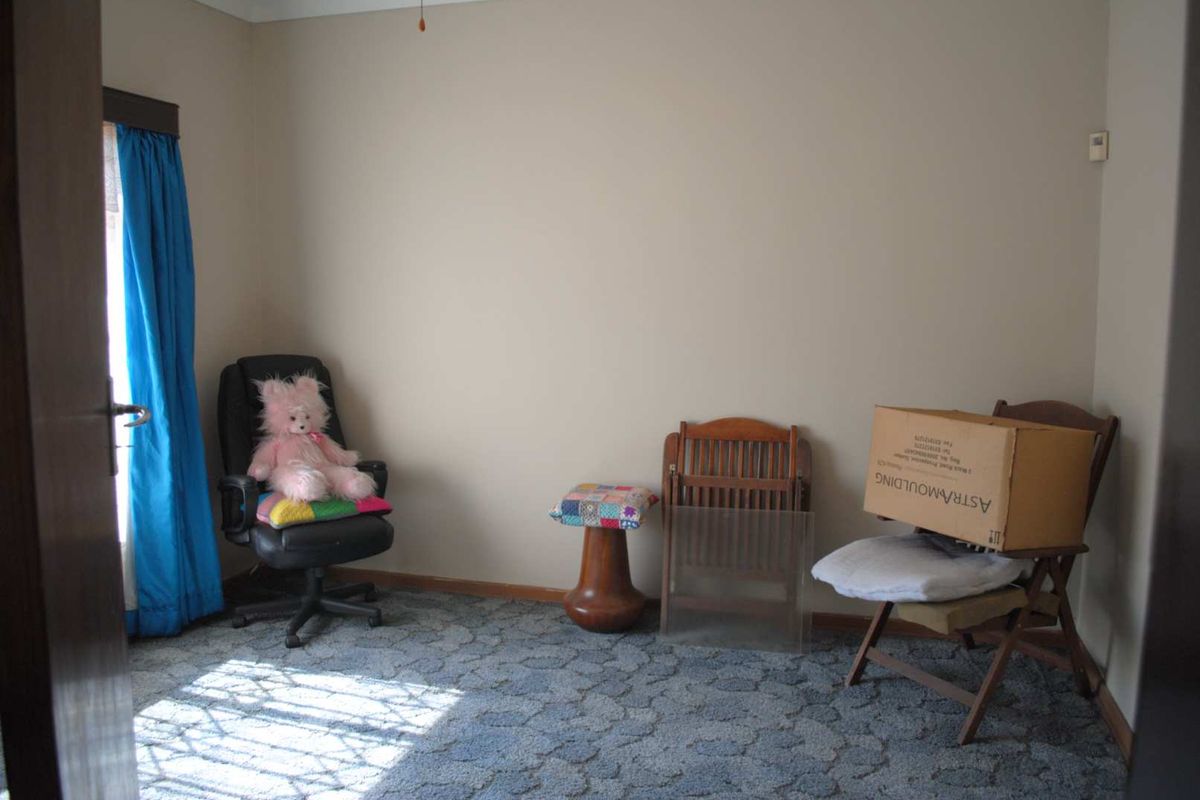 A bedroom featuring patterned carpet flooring and neutral wall paint, offering a blank canvas for potential interior updates.