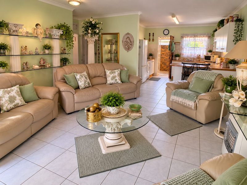 Open plan living and kitchen area featuring tiled flooring, neutral walls, and functional cabinetry, offering a spacious layout for comfortable daily living.