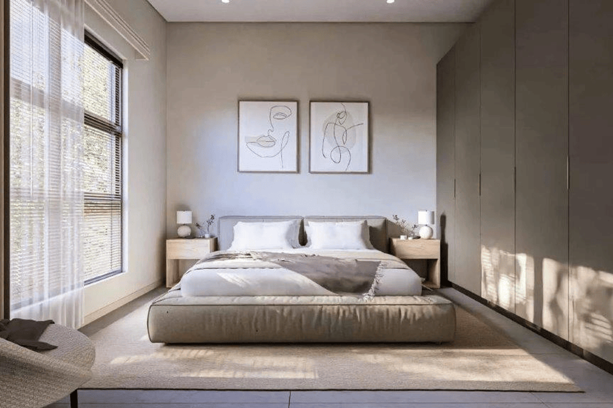 A modern, well-lit bedroom featuring extensive floor-to-ceiling built-in wardrobes and large windows with natural light.